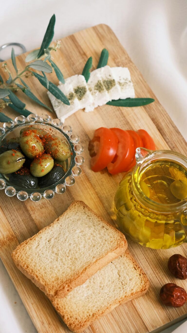 A delicious spread of Mediterranean appetizers including olives, feta cheese, and fresh herbs.