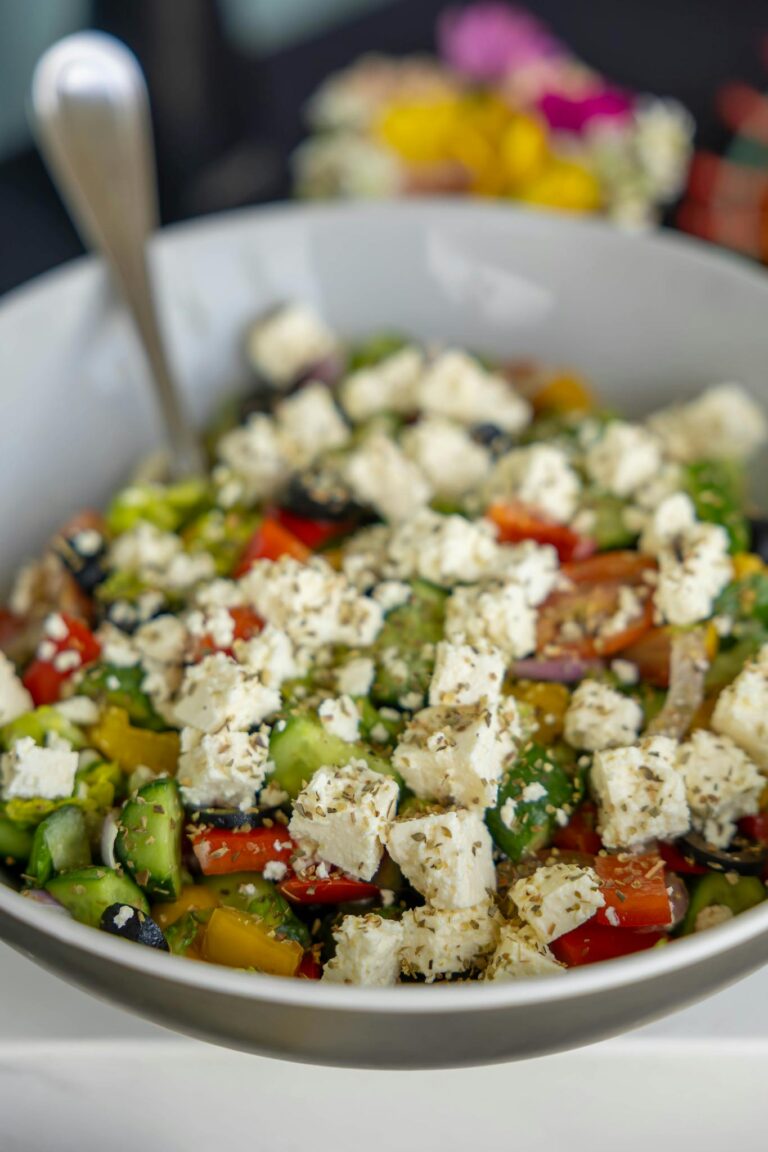 Vibrant Greek salad featuring fresh veggies, olives, and feta cheese cubes.